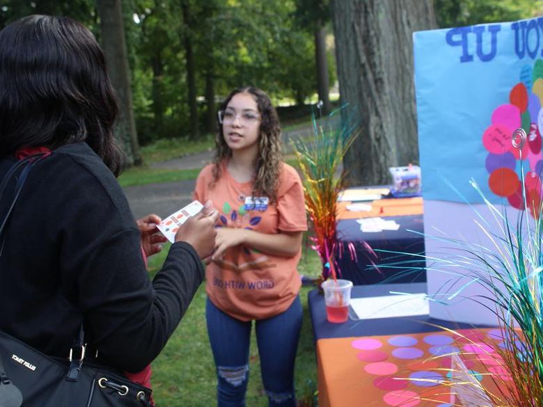 student speaking to another student at open house 